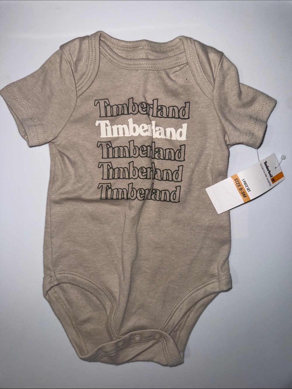 Timberland Beige Logo Repeat Baby Bodysuit